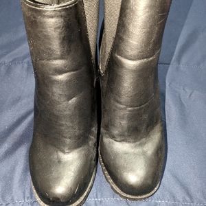 Distressed black Chelsea boots with three and a half inch block heel lug soul